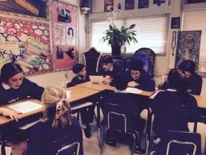 8th graders working with their kindergarten buddies on a writing assignment